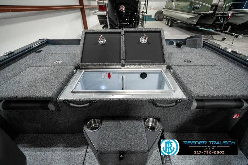 Slide: The Image of 2025 Lund 1875 Pro-V Bass XS boat interior with storage compartments and cup holders. - 23