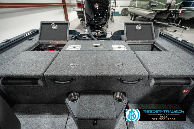 Slide: The Image of 2025 Lund 1875 Pro-V Bass XS boat interior with storage compartments and motor. - 24