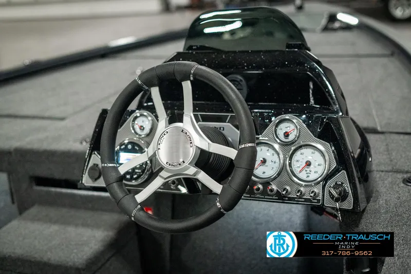 Slide: The Image of 2025 Lund 1875 Pro-V Bass XS dashboard with steering wheel and gauges. - 25