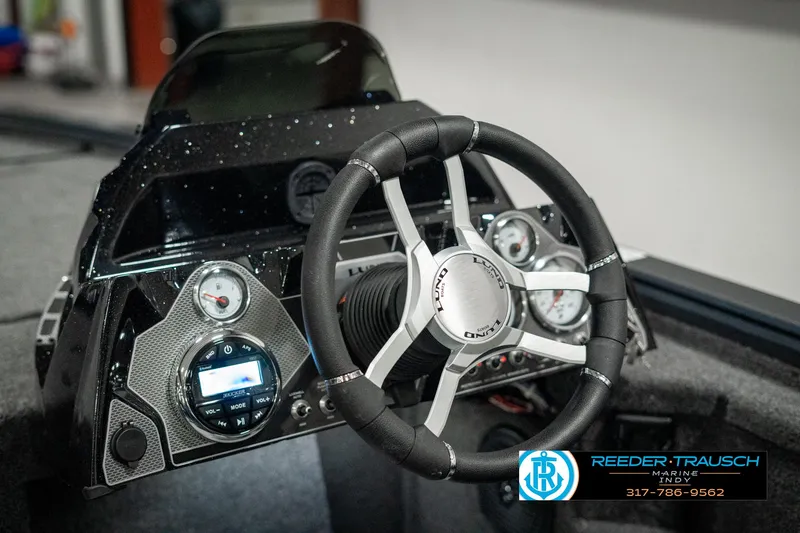 Slide: The Image of Dashboard of 2025 Lund 1875 Pro-V Bass XS boat with steering wheel and gauges. - 26