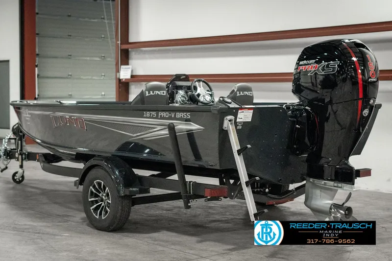 Slide: The Image of 2025 Lund 1875 Pro-V Bass XS boat on trailer in garage setting. - 4