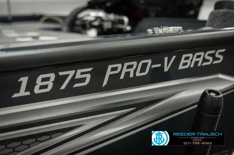 Slide: The Image of 2025 Lund 1875 Pro-V Bass XS boat detail with branding and design elements. - 47