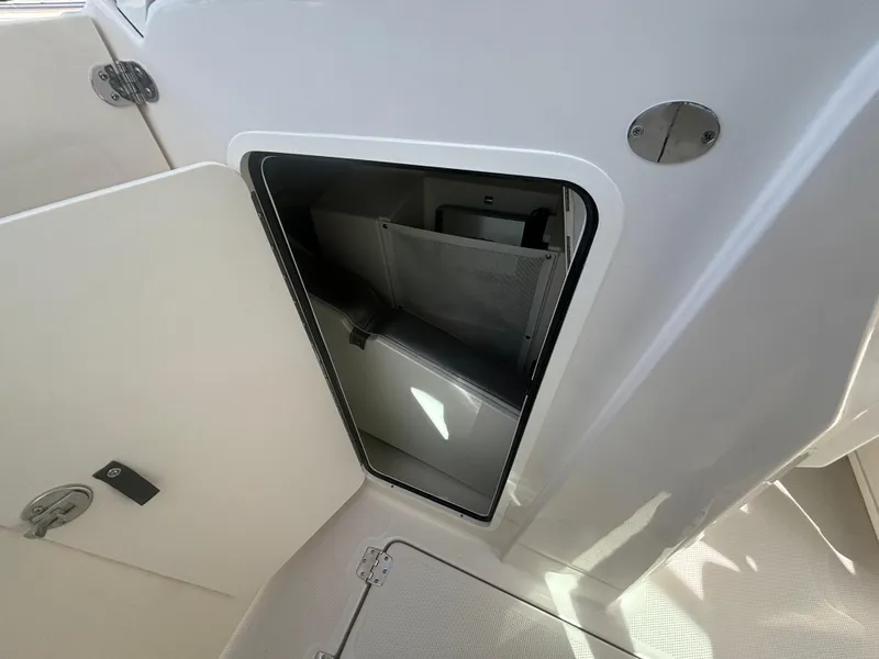Slide: The Image of Storage compartment on 2025 Sailfish 316 DC boat, open door view. - 15