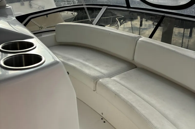 Slide: The Image of 1998 Silverton 352 Motor Yacht interior with curved seating and cup holders. - 13