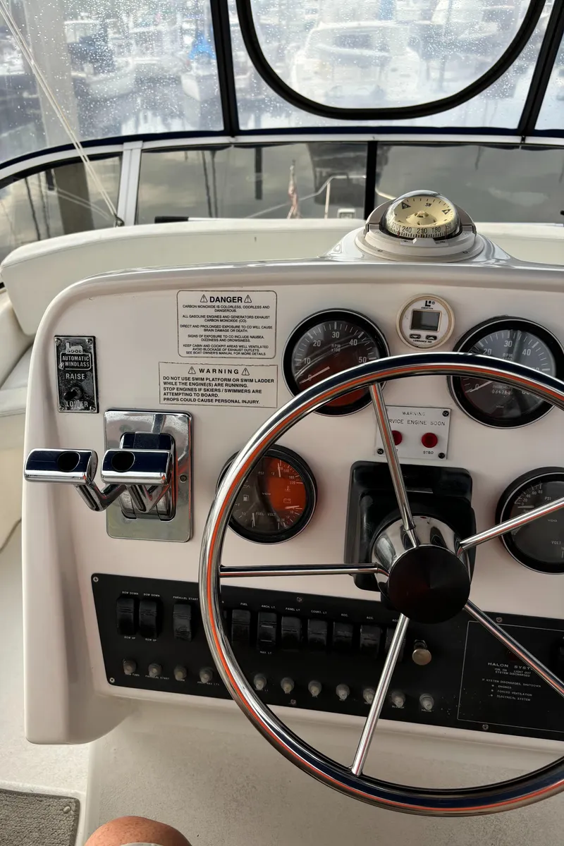Slide: The Image of 1998 Silverton 352 Motor Yacht helm with steering wheel and instrument panel. - 20