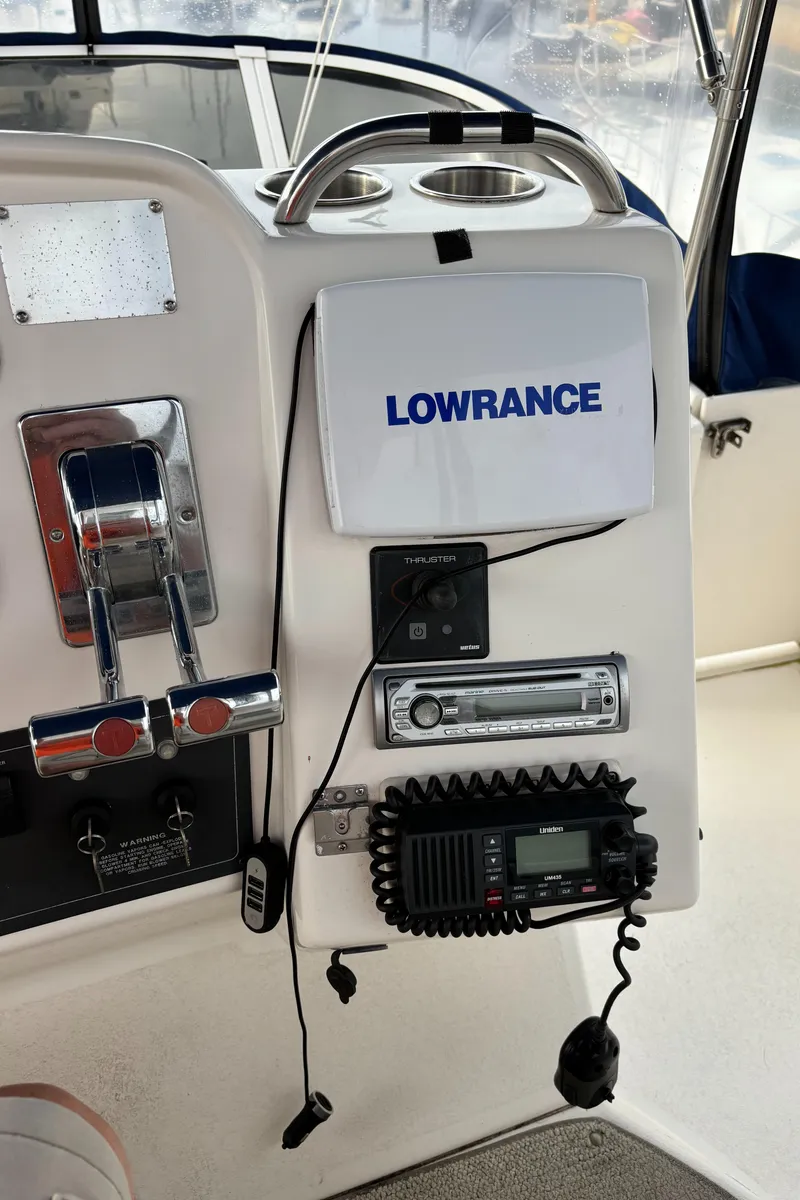 Slide: The Image of 1998 Silverton 352 Motor Yacht dashboard with Lowrance equipment and marine radio. - 22