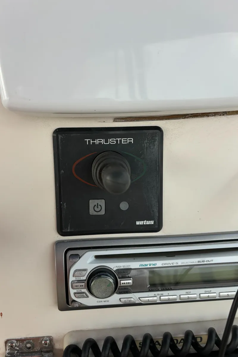 Slide: The Image of 1998 Silverton 352 Motor Yacht thruster control panel and marine radio. - 24