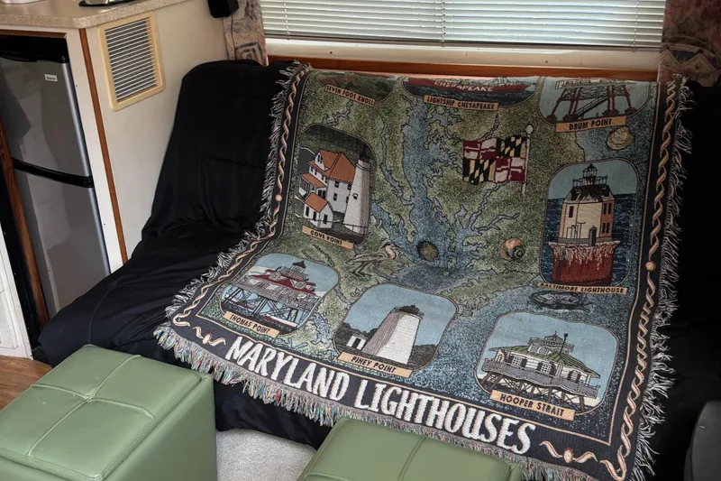 Slide: The Image of 1998 Silverton 352 Motor Yacht interior with Maryland lighthouses tapestry on sofa. - 27