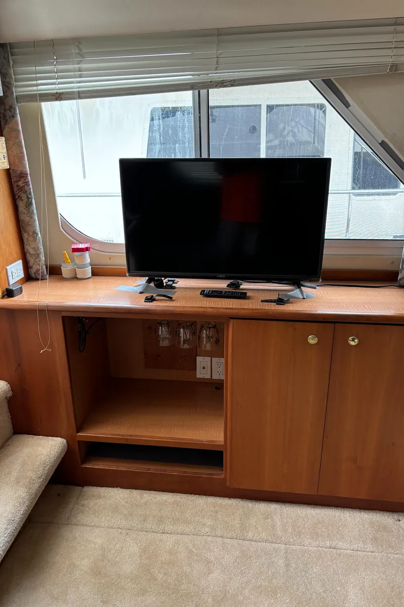 Slide: The Image of Interior of 1998 Silverton 352 Motor Yacht with TV and wooden cabinetry. - 31
