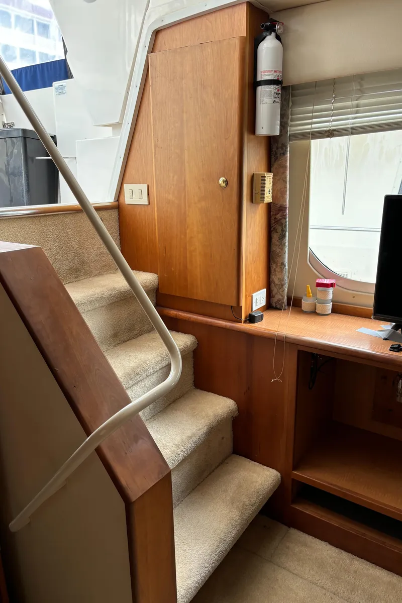 Slide: The Image of Interior of 1998 Silverton 352 Motor Yacht with stairs and wooden cabinetry. - 32