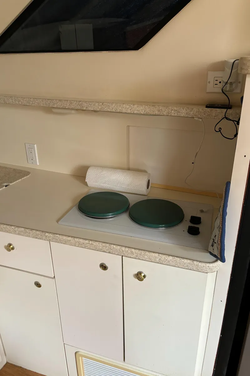 Slide: The Image of 1998 Silverton 352 Motor Yacht kitchen with stove and cabinets. - 34