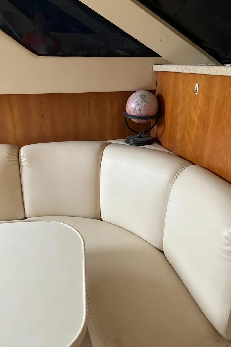 Slide: The Image of Interior of 1998 Silverton 352 Motor Yacht with white leather seating and globe decor. - 36
