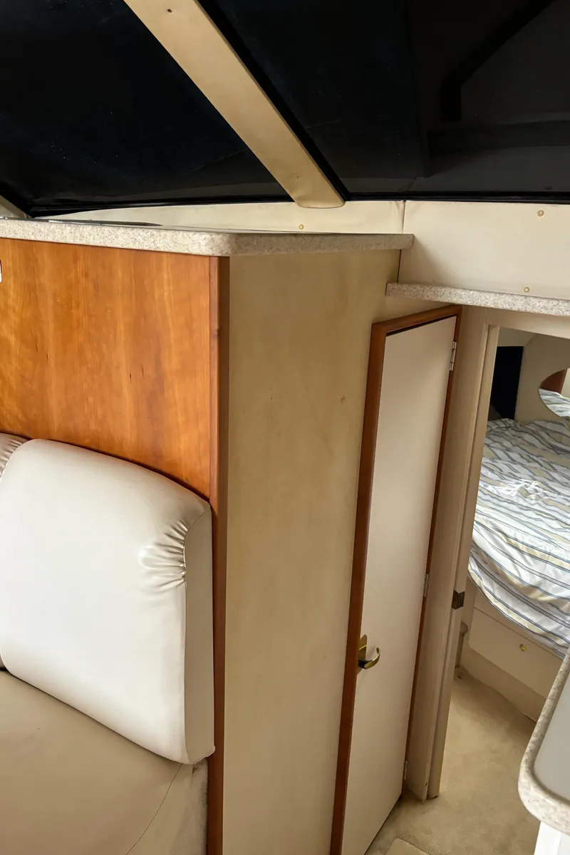 Slide: The Image of Interior of 1998 Silverton 352 Motor Yacht with cozy seating and cabin view. - 37