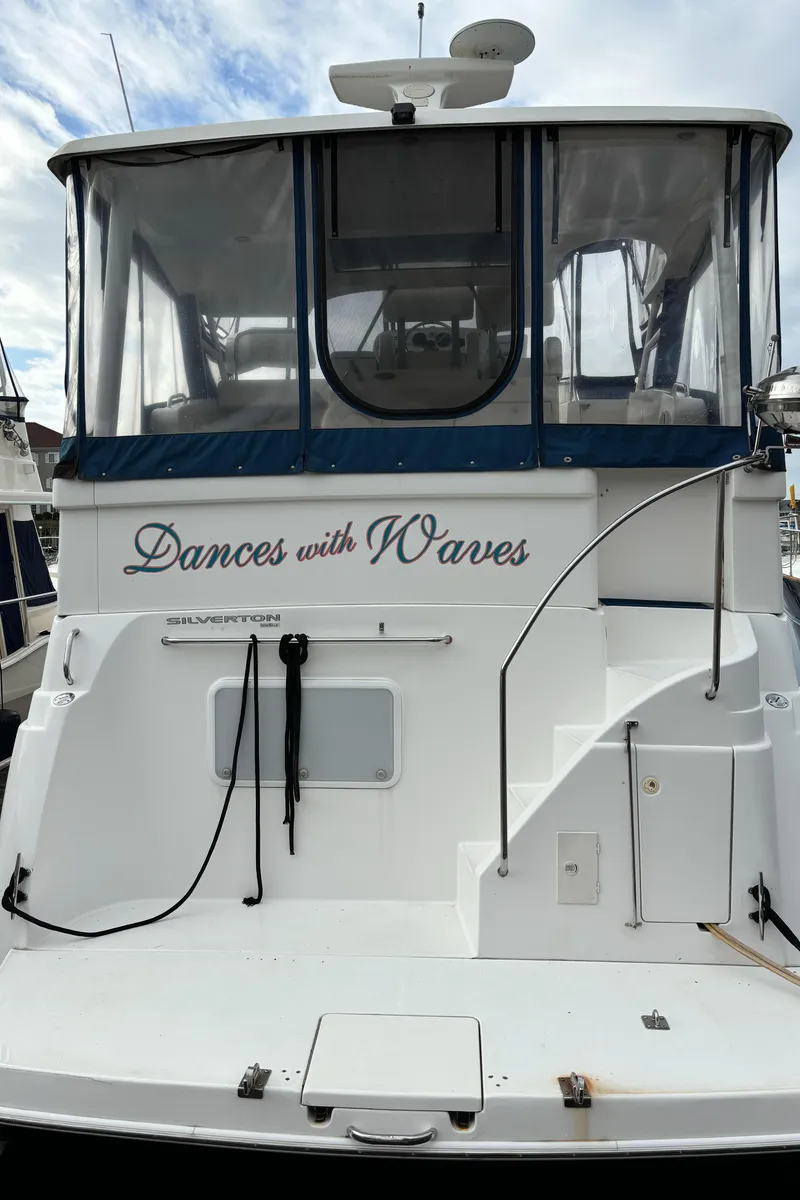 Slide: The Image of 1998 Silverton 352 Motor Yacht, "Dances with Waves," docked with clear skies. - 4