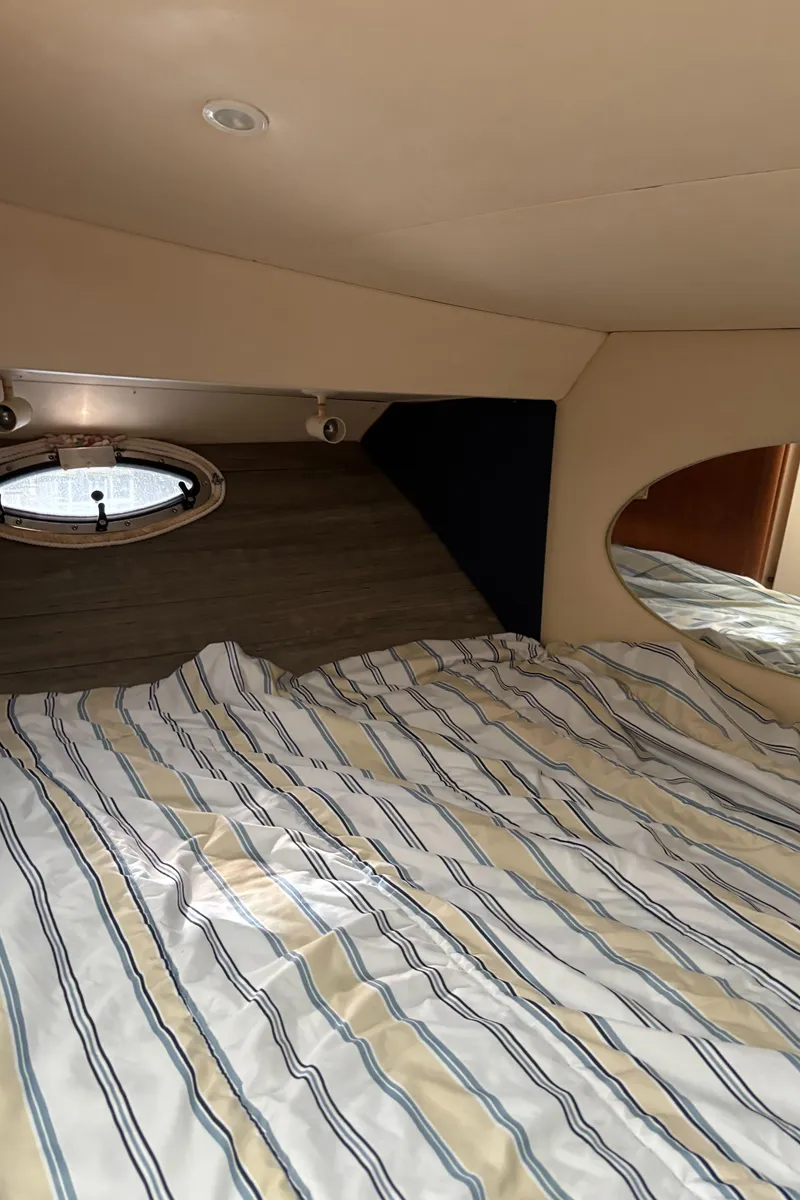 Slide: The Image of Interior cabin of 1998 Silverton 352 Motor Yacht with striped bedding. - 43