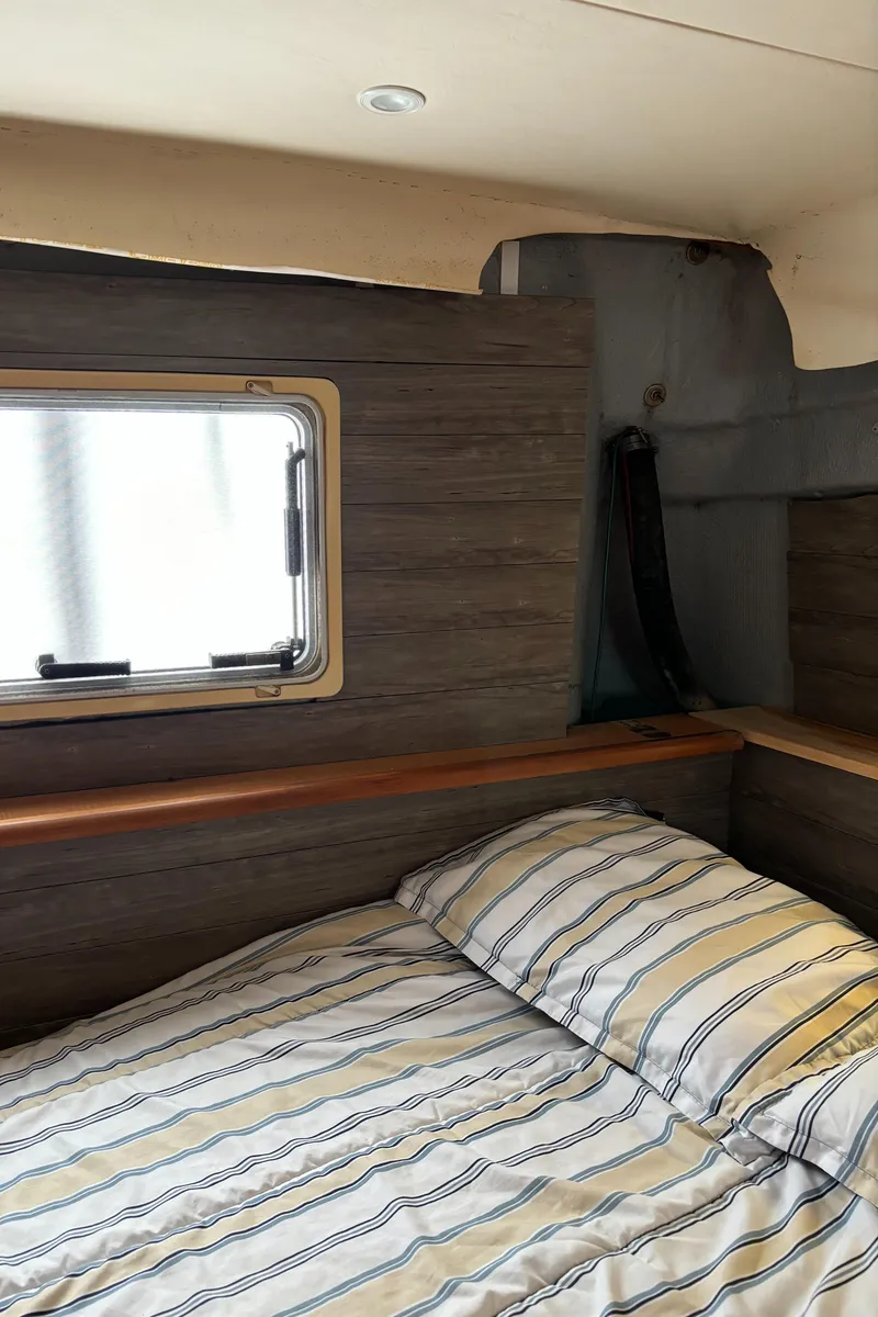 Slide: The Image of Interior cabin of 1998 Silverton 352 Motor Yacht with striped bedding. - 49