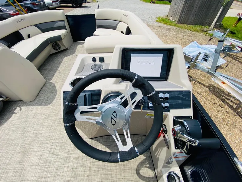 Slide: The Image of 2023 Harris Cruiser 230 boat interior with steering wheel and control panel. - 12