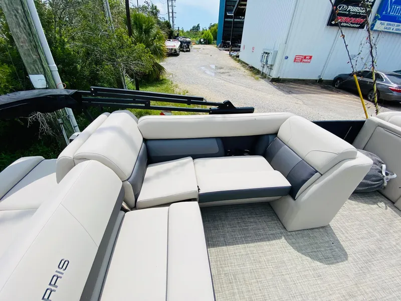 Slide: The Image of 2023 Harris Cruiser 230 boat interior with beige seating and open deck. - 14