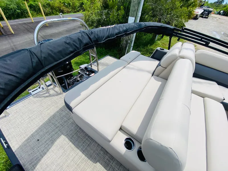 Slide: The Image of 2023 Harris Cruiser 230 boat with beige seating and cup holders. - 15