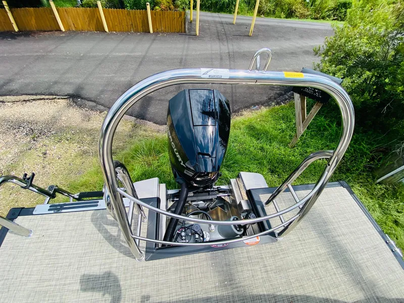 Slide: The Image of 2023 Harris Cruiser 230 boat engine and railing, viewed from above. - 16