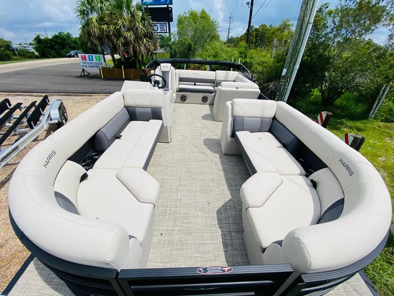 Slide: The Image of 2023 Harris Cruiser 230 pontoon boat with spacious seating and modern design. - 6