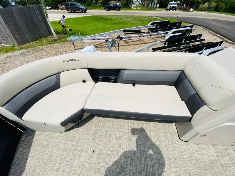 Slide: The Image of 2023 Harris Cruiser 230 boat interior with beige seating and outdoor setting. - 8