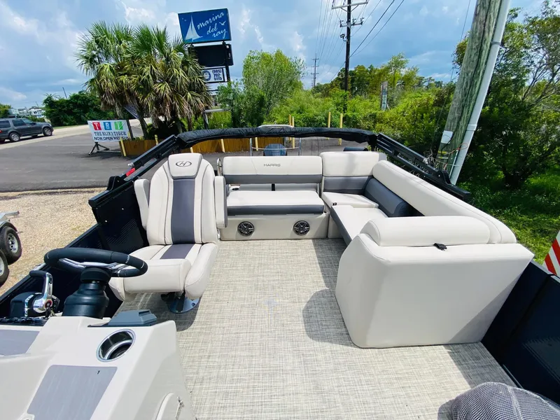 Slide: The Image of 2023 Harris Cruiser 230 pontoon boat with spacious seating and modern design. - 9