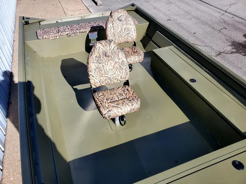 Slide: The Image of 2025 Lowe Roughneck RX2070 Tiller Steer boat with camo seats, docked on pavement. - 9