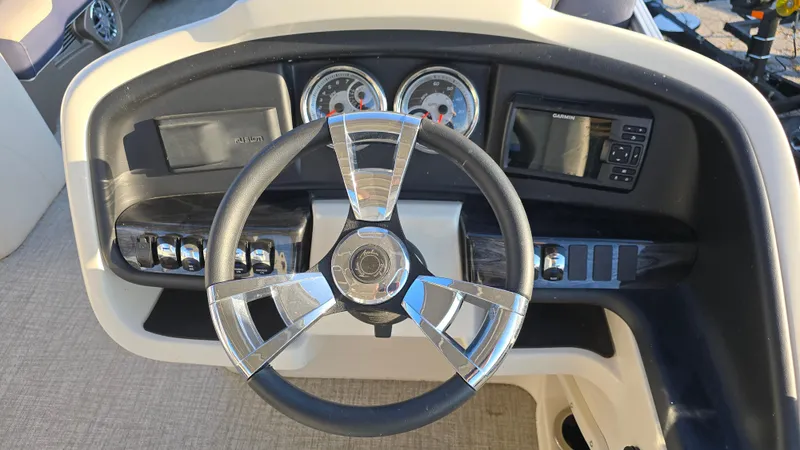 Slide: The Image of 2023 Avalon Catalina Cruise Funship dashboard with steering wheel and controls. - 11