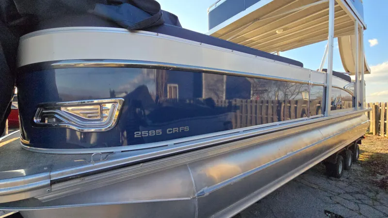 Slide: The Image of 2023 Avalon Catalina Cruise Funship 25' pontoon boat, blue and white exterior, side view. - 6