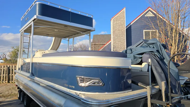 Slide: The Image of 2023 Avalon Catalina Cruise Funship pontoon boat with upper deck, parked outdoors. - 7