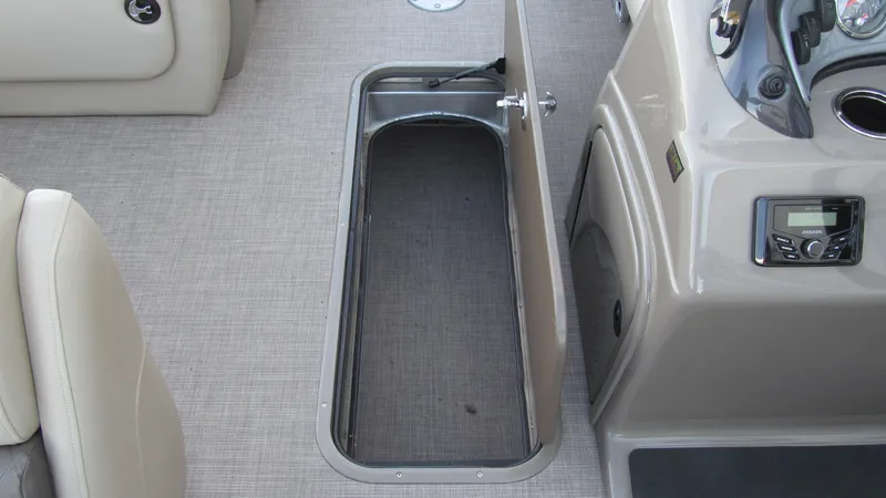 Slide: The Image of 2023 Sun Tracker SportFish 22 XP3 boat interior with open storage compartment. - 10