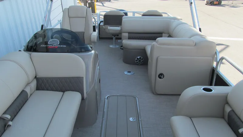 Slide: The Image of 2023 Sun Tracker SportFish 22 XP3 pontoon boat interior with beige seating and helm. - 11