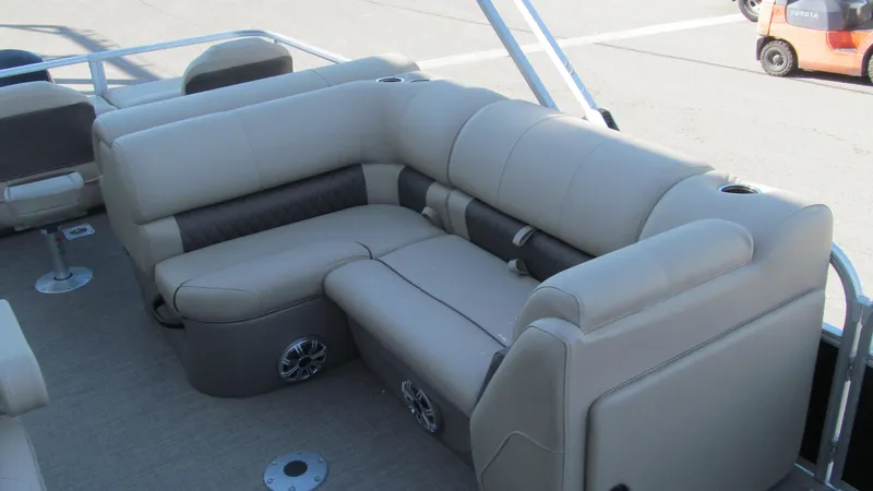 Slide: The Image of 2023 Sun Tracker SportFish 22 XP3 boat interior with beige seating and cup holders. - 12