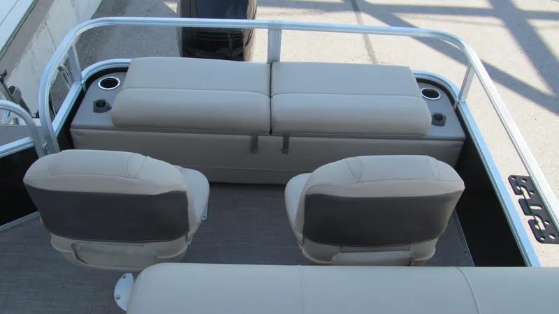 Slide: The Image of 2023 Sun Tracker SportFish 22 XP3 boat interior with cushioned seating and cup holders. - 13