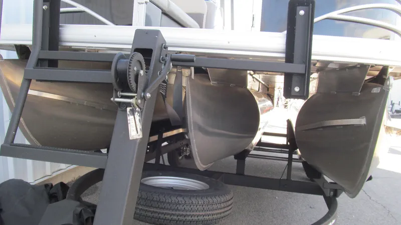 Slide: The Image of 2023 Sun Tracker SportFish 22 XP3 pontoon boat undercarriage and trailer view. - 3