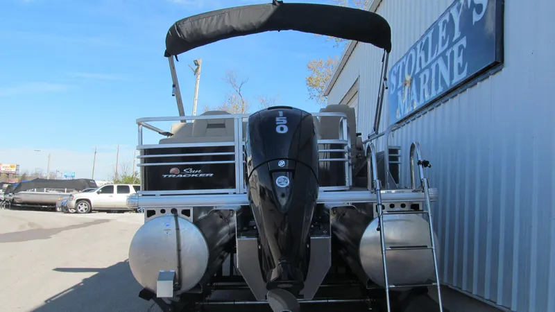 Slide: The Image of 2023 Sun Tracker SportFish 22 XP3 pontoon boat with outboard motor at marina. - 5