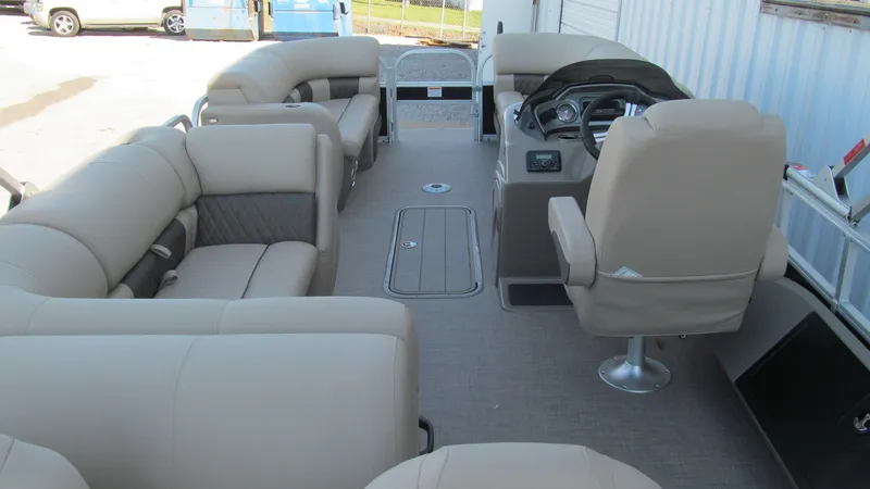 Slide: The Image of 2023 Sun Tracker SportFish 22 XP3 interior with beige seating and steering console. - 6