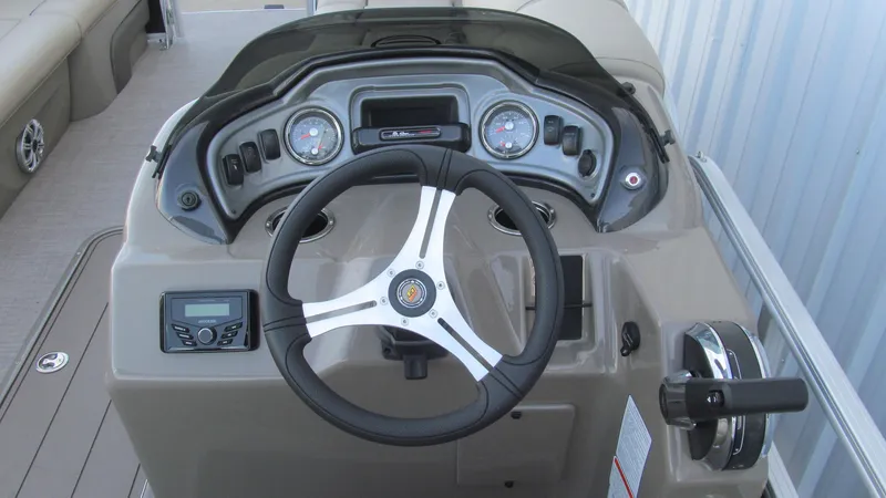 Slide: The Image of 2023 Sun Tracker SportFish 22 XP3 boat dashboard with steering wheel and controls. - 7