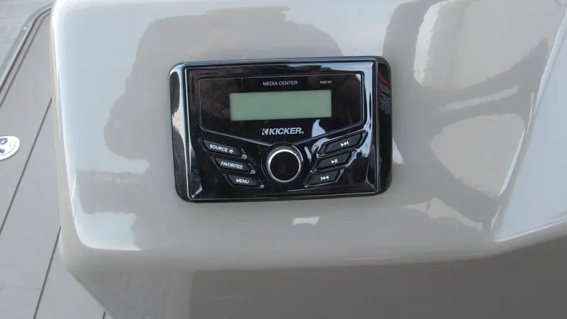 Slide: The Image of Kicker audio system on 2023 Sun Tracker SportFish 22 XP3 boat dashboard. - 8