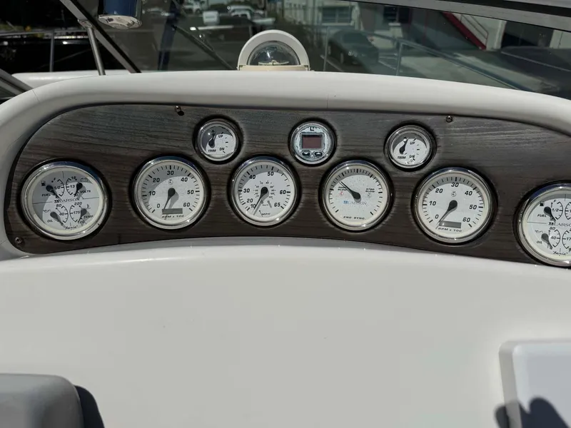 Slide: The Image of Dashboard of a 2002 Larson 310 CABRIO boat with multiple gauges. - 14