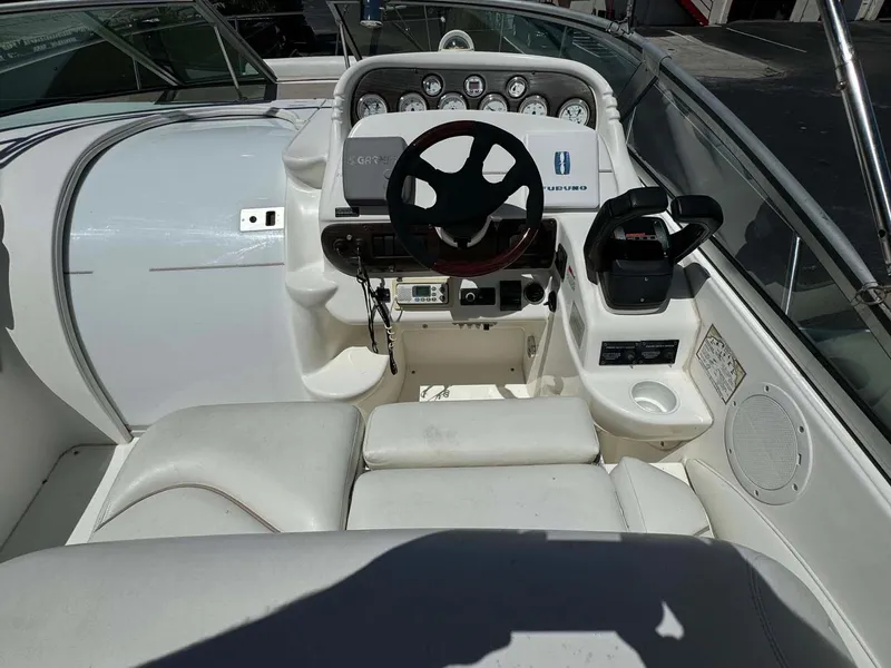 Slide: The Image of 2002 Larson 310 Cabrio boat cockpit with steering wheel and control panel. - 15