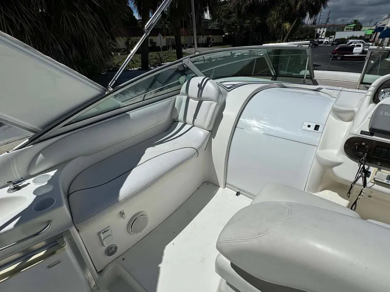 Slide: The Image of 2002 Larson 310 Cabrio boat interior with white seating and dashboard. - 16