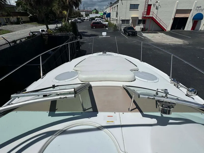 Slide: The Image of 2002 Larson 310 Cabrio boat deck with sunpad, docked in urban marina. - 17