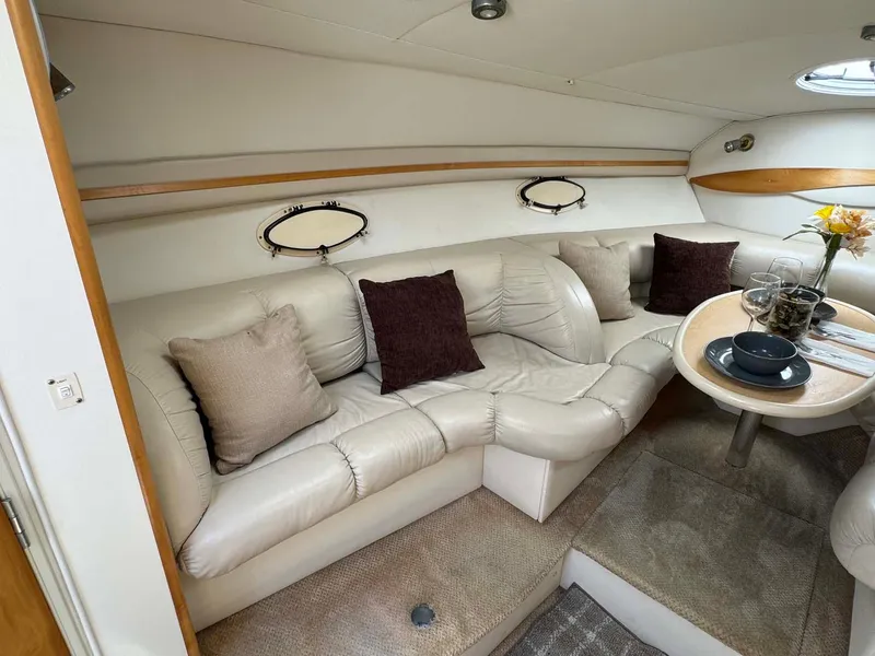 Slide: The Image of Luxurious interior of 2002 Larson 310 Cabrio yacht with plush seating and dining area. - 19