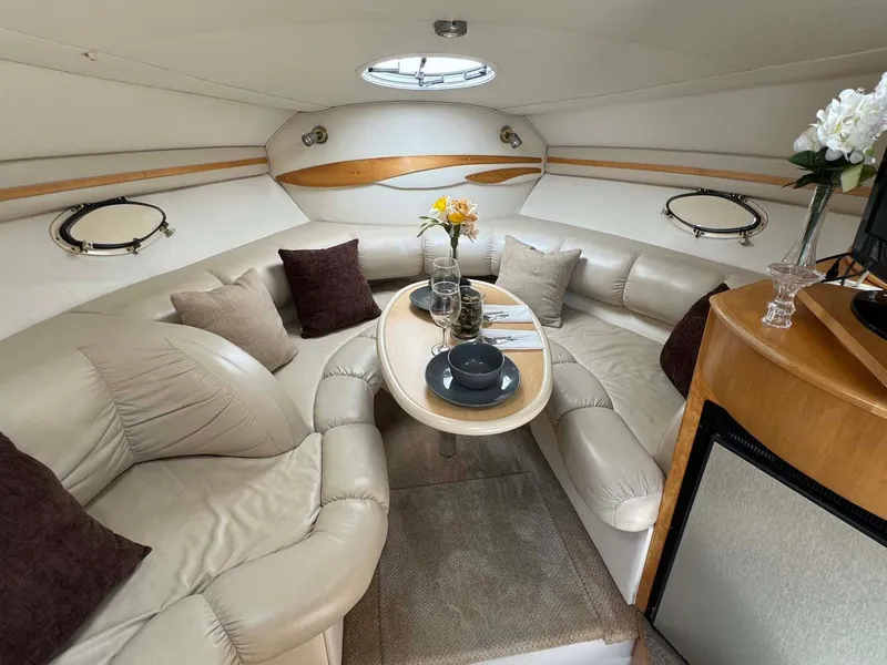 Slide: The Image of Luxurious interior of 2002 Larson 310 Cabrio yacht with plush seating and elegant decor. - 21