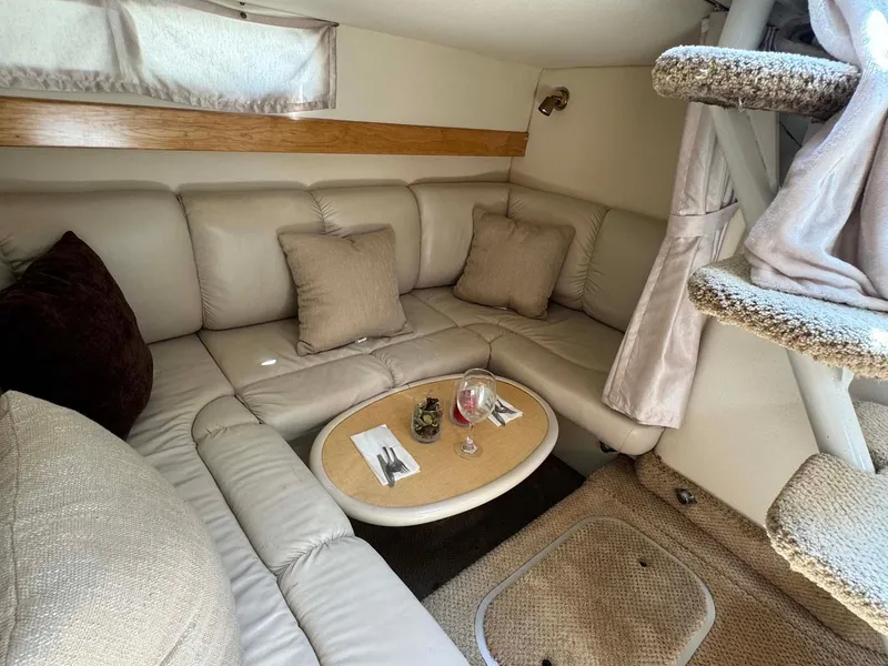 Slide: The Image of Interior of 2002 Larson 310 Cabrio with cozy seating and dining area. - 27