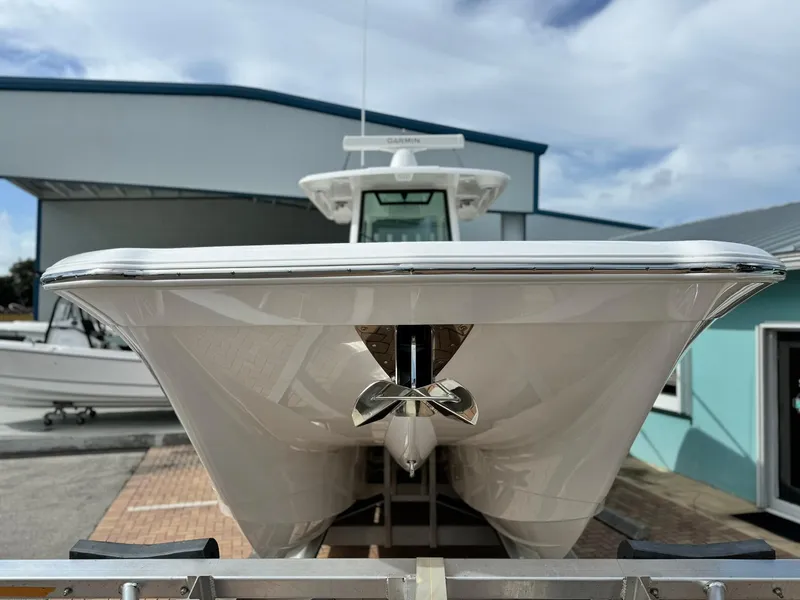 Slide: The Image of 2025 Caymas 30 CT boat on trailer, front view, outdoors. - 1