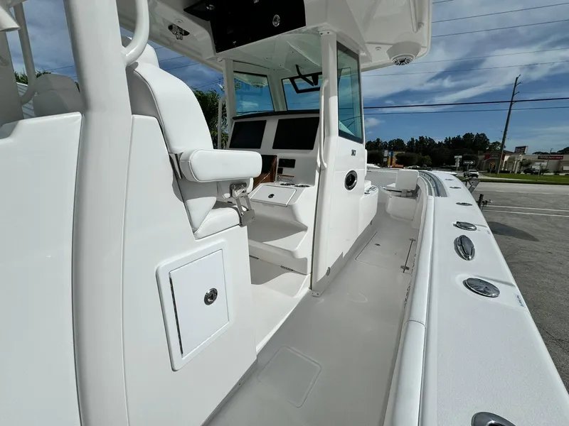 Slide: The Image of 2025 Caymas 30 CT boat interior with sleek white design and modern controls. - 10