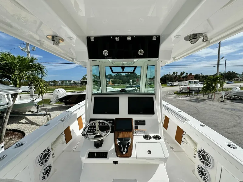 Slide: The Image of 2025 Caymas 30 CT boat cockpit with modern controls and dual screens. - 11